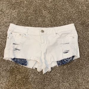 White cutoff ripped shorts